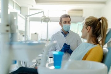 Patient and dentist talking about post-op instructions