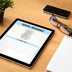 Dental insurance paperwork on tablet